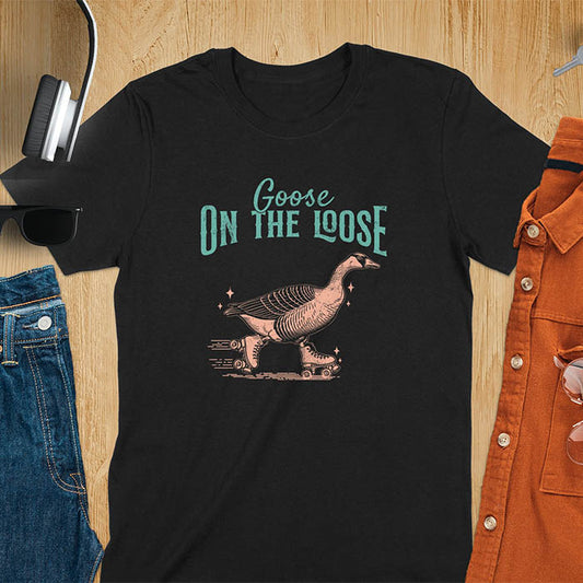 "Goose on the Loose" shirt features a goose on roller skates in motion, with vintage distressed font and colors. Perfect for fans of funny goose shirts, meme tees, sarcastic shirts, silly goose vibes, Y2K clothing, and animal lover gifts.