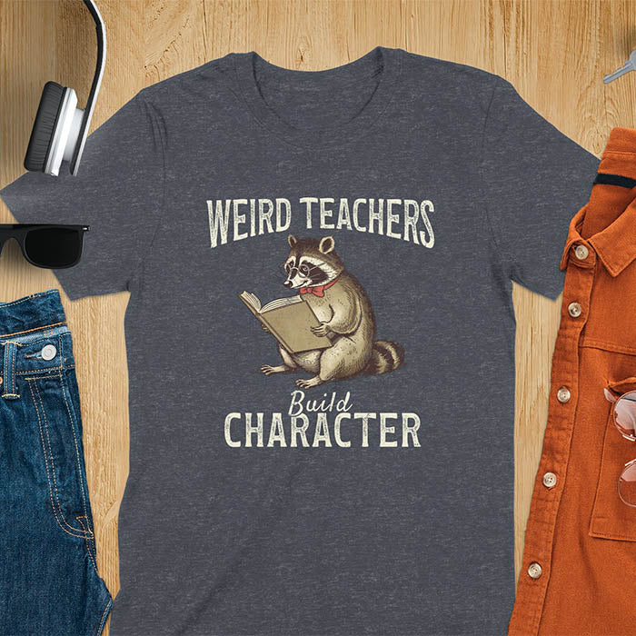 Weird Teachers Build Character shirt featuring a raccoon reading a book with glasses and a red bow tie. Vintage distressed font and brownish monotone give it a retro look. Perfect back-to-school shirt, funny teacher gift, or teacher appreciation tee.
