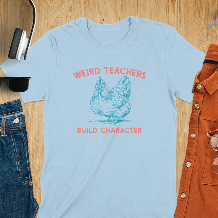 This teacher t-shirt features a grumpy-faced hen. The vintage font with distressed effect says Weird Teachers above the hen and Build Character below, all in a vintage color palette.