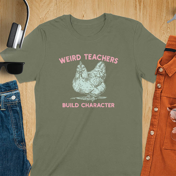 This teacher t-shirt features a grumpy-faced hen. The vintage font with distressed effect says Weird Teachers above the hen and Build Character below, all in a vintage color palette.