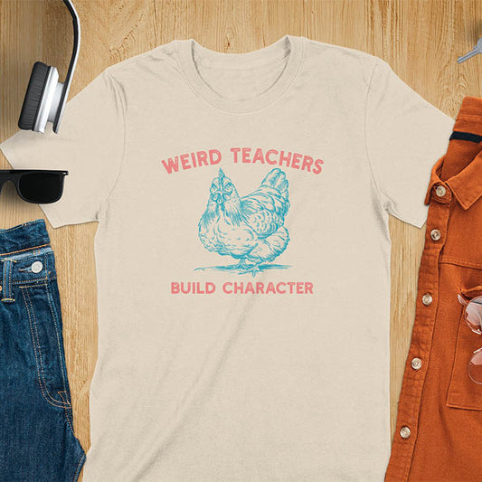 This teacher t-shirt features a grumpy-faced hen. The vintage font with distressed effect says Weird Teachers above the hen and Build Character below, all in a vintage color palette.