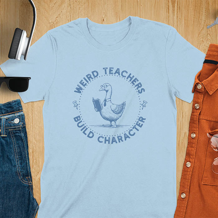 The design features a cartoon goose wearing glasses and holding a book. Surrounding the goose, there is text that reads, WEIRD TEACHERS BUILD CHARACTER.
