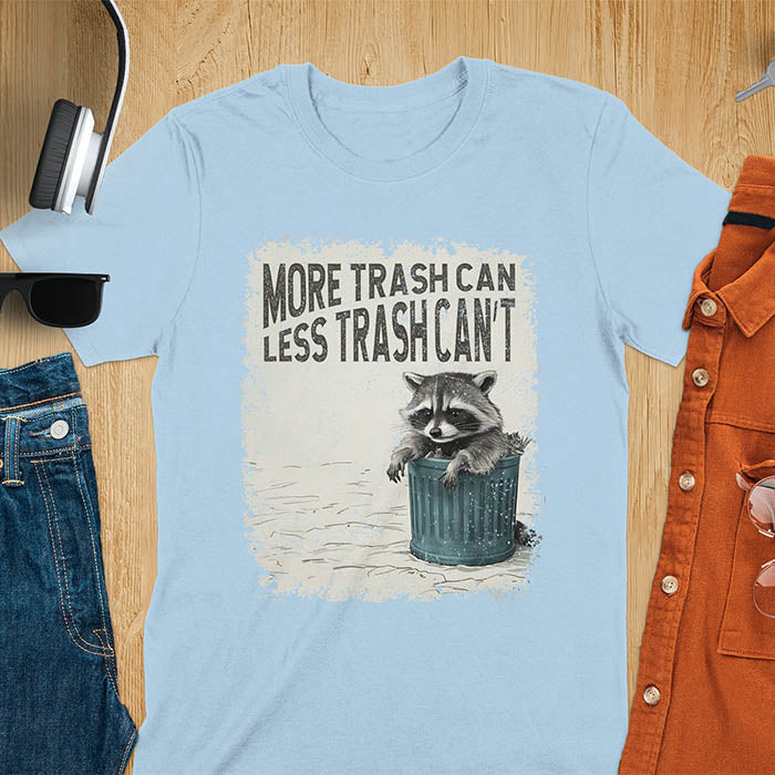 Raccoon lounging on a blue trash can with text "More Trash Can, Less Trash Can't." Distressed texture with vintage font. Perfect for animal lovers, sarcastic shirts, raccoon gifts, and fans of retro funny tees.