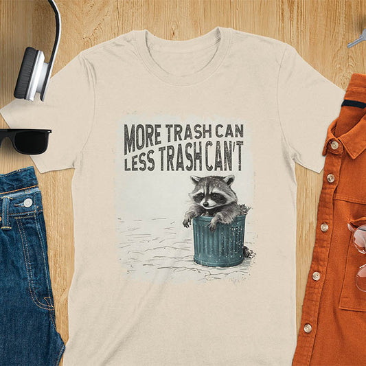 Raccoon lounging on a blue trash can with text "More Trash Can, Less Trash Can't." Distressed texture with vintage font. Perfect for animal lovers, sarcastic shirts, raccoon gifts, and fans of retro funny tees.
