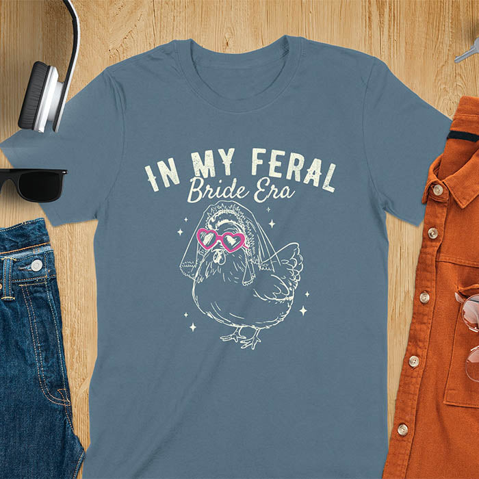 A chicken wearing sunglasses and a bride's veil, with the text "In My Feral Bride Era".