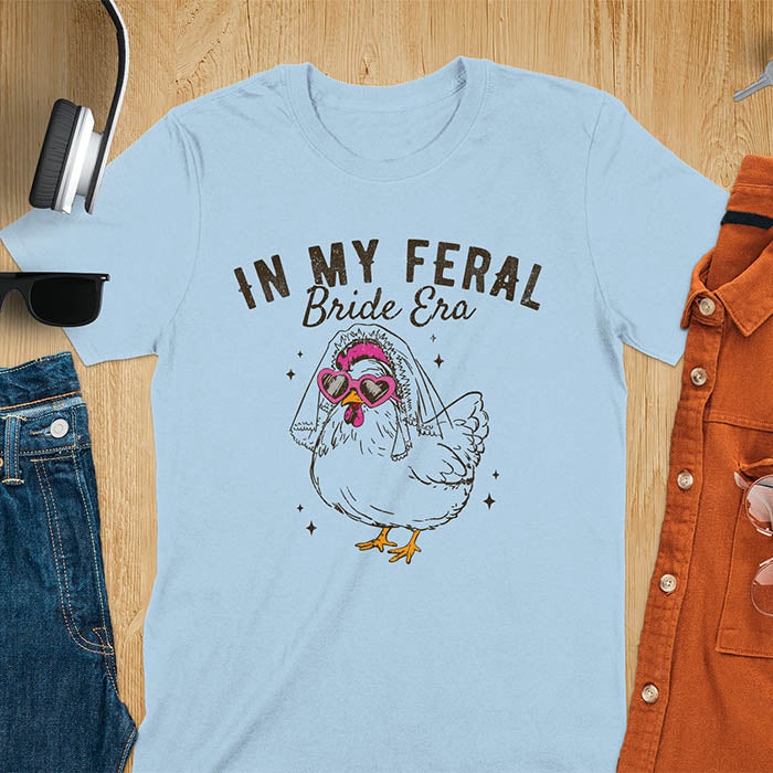 A chicken wearing sunglasses and a bride's veil, with the text "In My Feral Bride Era".