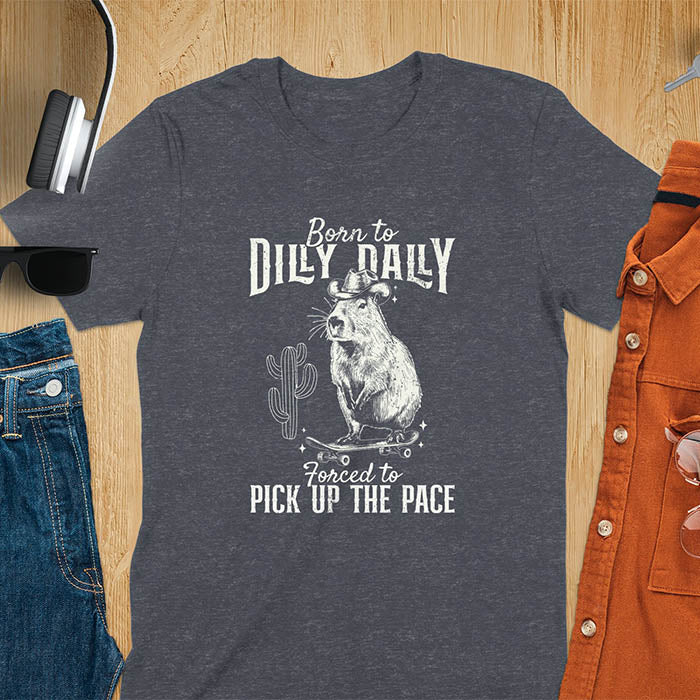 Capybara in a cowboy hat on a skateboard western style. Born to Dilly Dally and Forced to Pick Up the Pace text. Distressed style.