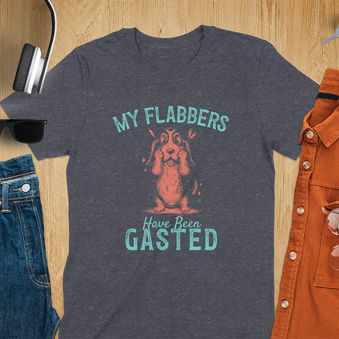 A t-shirt with a startled basset hound puppy. Its characteristic drooping ears are shown, and small lightning bolts radiate from its head. Text: "MY FLABBERS Have Been GASTED". This cute dog tee-shirt displays dog cuteness & cuteness puppy. A funny dog shirt & dog lover gift for dog person, dog mom, dog dad, dog owner. A retro dog shirt & vintage dog tee, animal person gift, gift for mom, hers.