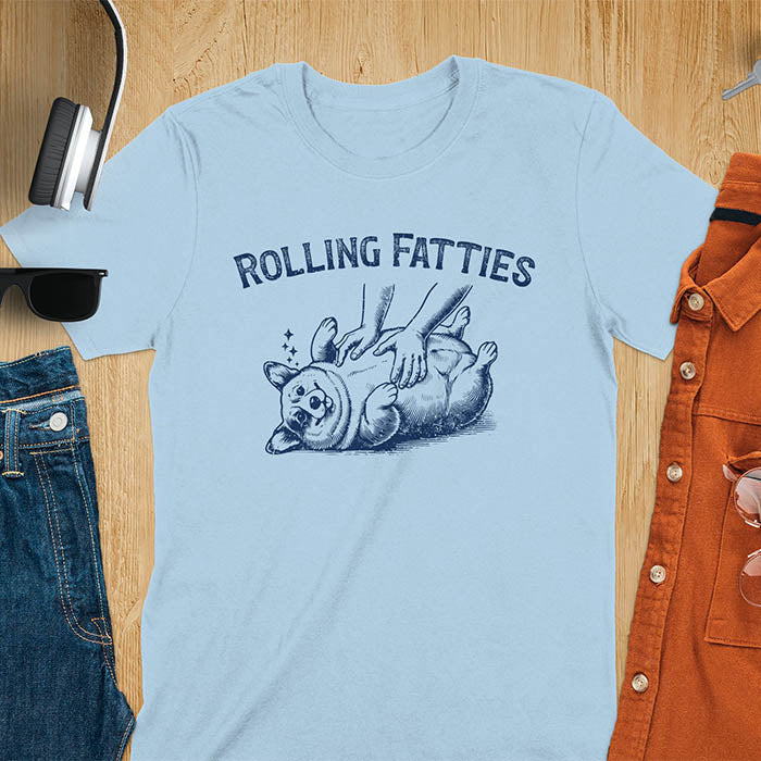 Quirky, trendy t-shirt with funny nostalgia and Y2K doggie pet vet vibes. Features a fat cute corgi and ROLLING FATTIES text. Perfect for corgi dad lovers and mom graphic owners. crewneck outfit with a retro aesthetic.
