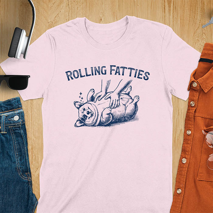 Quirky, trendy t-shirt with funny nostalgia and Y2K doggie pet vet vibes. Features a fat cute corgi and ROLLING FATTIES text. Perfect for corgi dad lovers and mom graphic owners. crewneck outfit with a retro aesthetic.