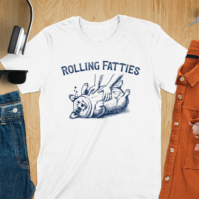 Quirky, trendy t-shirt with funny nostalgia and Y2K doggie pet vet vibes. Features a fat cute corgi and ROLLING FATTIES text. Perfect for corgi dad lovers and mom graphic owners. crewneck outfit with a retro aesthetic.