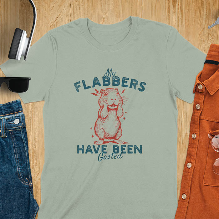 A t-shirt with a startled baby capybara covering its mouth. Text: "My FLABBERS Have Been GASTED". This sarcastic t-shirt is weird silly funny, a Gen Z meme tee & funny gag gift. It has weirdcore memes, vintage retro unhinged tee-shirt appeal & makes shirts that go hard. An animal person gift, animal lover gift, cute animal lover gift, gift mom hers, for kawaiiness cuteness.