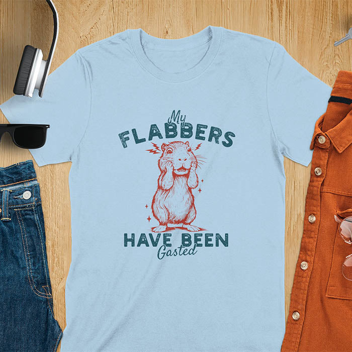 A t-shirt with a startled baby capybara covering its mouth. Text: "My FLABBERS Have Been GASTED". This sarcastic t-shirt is weird silly funny, a Gen Z meme tee & funny gag gift. It has weirdcore memes, vintage retro unhinged tee-shirt appeal & makes shirts that go hard. An animal person gift, animal lover gift, cute animal lover gift, gift mom hers, for kawaiiness cuteness.