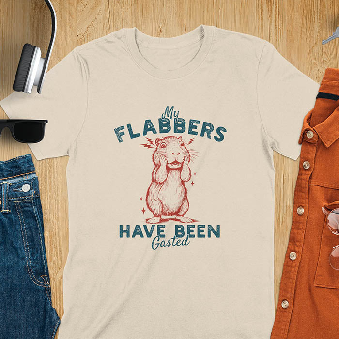 A t-shirt with a startled baby capybara covering its mouth. Text: "My FLABBERS Have Been GASTED". This sarcastic t-shirt is weird silly funny, a Gen Z meme tee & funny gag gift. It has weirdcore memes, vintage retro unhinged tee-shirt appeal & makes shirts that go hard. An animal person gift, animal lover gift, cute animal lover gift, gift mom hers, for kawaiiness cuteness.