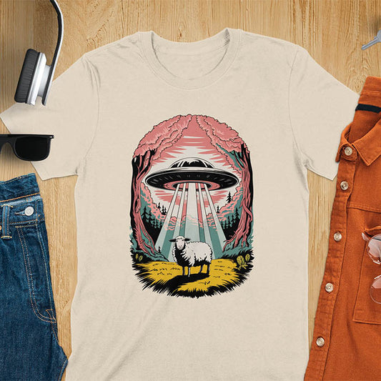 A t-shirt with a UFO hovering over a sheep in a forest scene. This alien tshirt depicts ufo alien abductions with a cute sheep. A weird shirt and funny alien gift, one of those oddly specific tees. A graphic tee-shirt with a 90s graphic tee style. A farm animal gifts or animal person gift. A farmer t shirt or farming shirt, a mom gift alternative.