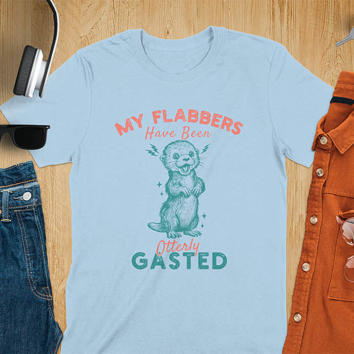 A t-shirt with a startled-looking otter holding its paws in front of its chest. Sparkles surround the otter. Text: "MY FLABBERS" above and "HAVE BEEN Otterly GASTED" below. This weird silly funny tee shows Kawaiiness cuteness and Otter cuteness, a great Otter lover gift. A Sarcastic t-shirt and Funny gag gift, a Gen Z meme tee tapping into Weirdcore memes. An Animal person gift and Gift for mom, hers, one of the Shirts that go hard featuring a Cute sea otter.