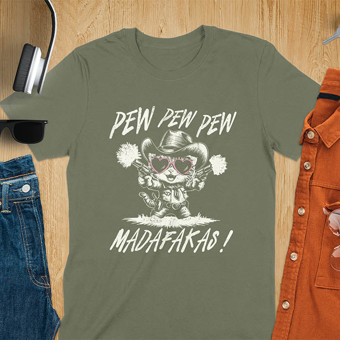 A t-shirt with a cat in a cowboy outfit wearing heart sunglasses and holding two pistols. Text: "PEW PEW PEW" above and "MADAFAKAS!" below. This funny meme t shirt features a funny cowboy cat with a sarcastic quote. A funny genz meme and sarcastic meme shirt, a snarky humorous funny adult joke. An animal person gift or gift for mom, a sassy quote funny funny fuck gift.