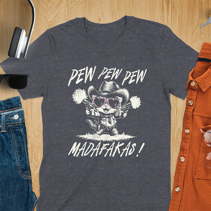 A t-shirt with a cat in a cowboy outfit wearing heart sunglasses and holding two pistols. Text: "PEW PEW PEW" above and "MADAFAKAS!" below. This funny meme t shirt features a funny cowboy cat with a sarcastic quote. A funny genz meme and sarcastic meme shirt, a snarky humorous funny adult joke. An animal person gift or gift for mom, a sassy quote funny funny fuck gift.