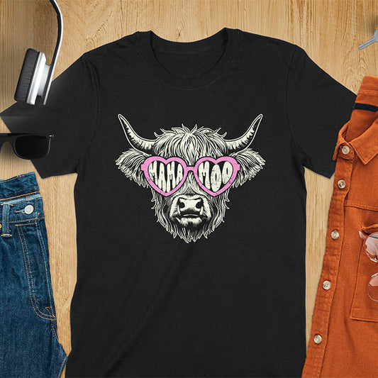 A t-shirt featuring a fluffy highland cow face with long horns, wearing pink heart-shaped sunglasses spelling MAMA MOO. Below the cow, Veronica is written in script font. This retro mom tee-shirt design is a cute cow highlander for mama mom life. A funny animal mom tee for an expecting mom or pregnant mom gift, ideal for a pregnancy announcement or pregnancy reveal. A great mom gift or Mother days gift, or a new mom gift for a gift for wife. The name can be personalized.