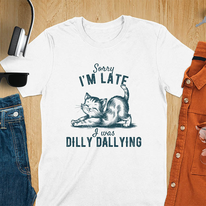 A t-shirt with a kitten stretching its back. Text: Sorry I'M LATE above and I was DILLY DALLYING below. This cat lover shirt features cat cuteness gift and kawaiiness cuteness. A sarcastic meme shirt about dilly dally, a funny genz meme with funny animals. This kawaii kitten design has vintage aesthetics, a snarky humorous tee, an animal person gift or mom gift hers. A cat mom t shirt alternative.