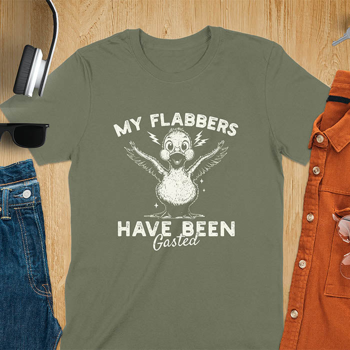 A t-shirt with a startled goose flapping its wings. Text: "MY FLABBERS" above and "HAVE BEEN GASTED" below. This Sarcastic tee-shirt features Kawaiiness cuteness and goose cuteness, a GenZ meme tee. A Funny gag gift and Anxiety t-shirt, a silly funny goose. A funny goose shirt tapping into Weirdcore memes and weirdcore t shirt aesthetics. An animal person gift or goose lover gifts, a Mom gift alternative.