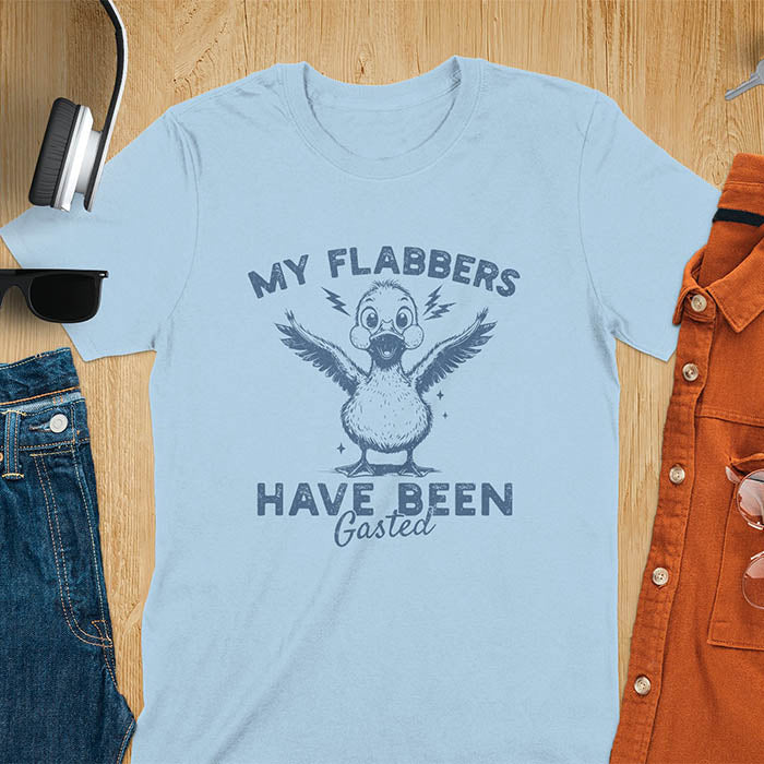 A t-shirt with a startled goose flapping its wings. Text: "MY FLABBERS" above and "HAVE BEEN GASTED" below. This Sarcastic tee-shirt features Kawaiiness cuteness and goose cuteness, a GenZ meme tee. A Funny gag gift and Anxiety t-shirt, a silly funny goose. A funny goose shirt tapping into Weirdcore memes and weirdcore t shirt aesthetics. An animal person gift or goose lover gifts, a Mom gift alternative.