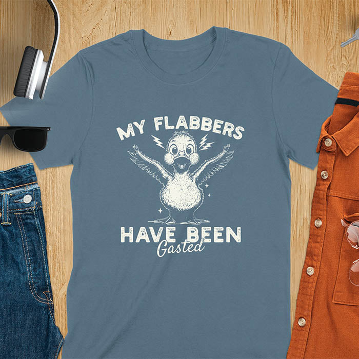 A t-shirt with a startled goose flapping its wings. Text: "MY FLABBERS" above and "HAVE BEEN GASTED" below. This Sarcastic tee-shirt features Kawaiiness cuteness and goose cuteness, a GenZ meme tee. A Funny gag gift and Anxiety t-shirt, a silly funny goose. A funny goose shirt tapping into Weirdcore memes and weirdcore t shirt aesthetics. An animal person gift or goose lover gifts, a Mom gift alternative.