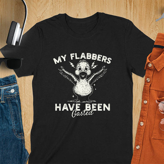 A t-shirt with a startled goose flapping its wings. Text: "MY FLABBERS" above and "HAVE BEEN GASTED" below. This Sarcastic tee-shirt features Kawaiiness cuteness and goose cuteness, a GenZ meme tee. A Funny gag gift and Anxiety t-shirt, a silly funny goose. A funny goose shirt tapping into Weirdcore memes and weirdcore t shirt aesthetics. An animal person gift or goose lover gifts, a Mom gift alternative.
