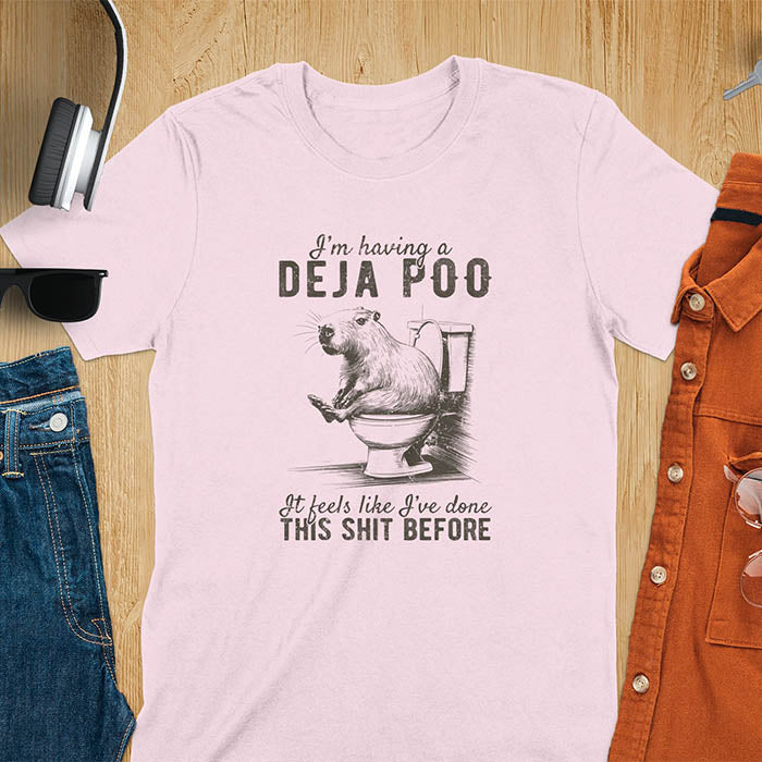 A t-shirt with a capybara seated on a toilet bowl. Text: "I'm having a Deja Poo It feels like I've done THIS SHIT BEFORE". A Capybara Deja Poo Shirt with Toilet Humor Gag Gift appeal. Inappropriate, offensive, weirdcore, funny meme, trending meme, genz gen z tee. Features kawaiiness, capybara cuteness, weird capybara gift. Great for animal person, pet lovers, animal lover, gift mom hers. A Retro Graphic Tshirt, y2k tee-shirt, Vintage Silly Party Tees, shirts that go hard.