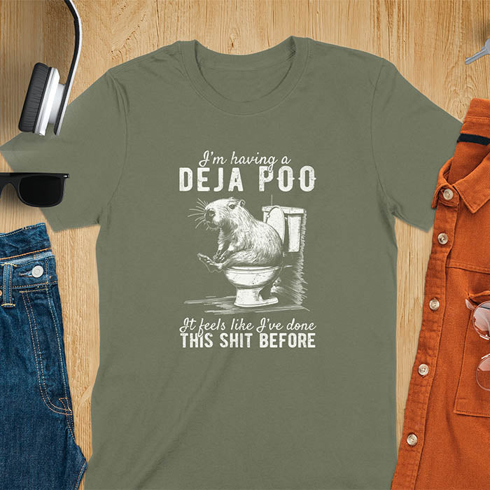 A t-shirt with a capybara seated on a toilet bowl. Text: "I'm having a Deja Poo It feels like I've done THIS SHIT BEFORE". A Capybara Deja Poo Shirt with Toilet Humor Gag Gift appeal. Inappropriate, offensive, weirdcore, funny meme, trending meme, genz gen z tee. Features kawaiiness, capybara cuteness, weird capybara gift. Great for animal person, pet lovers, animal lover, gift mom hers. A Retro Graphic Tshirt, y2k tee-shirt, Vintage Silly Party Tees, shirts that go hard.