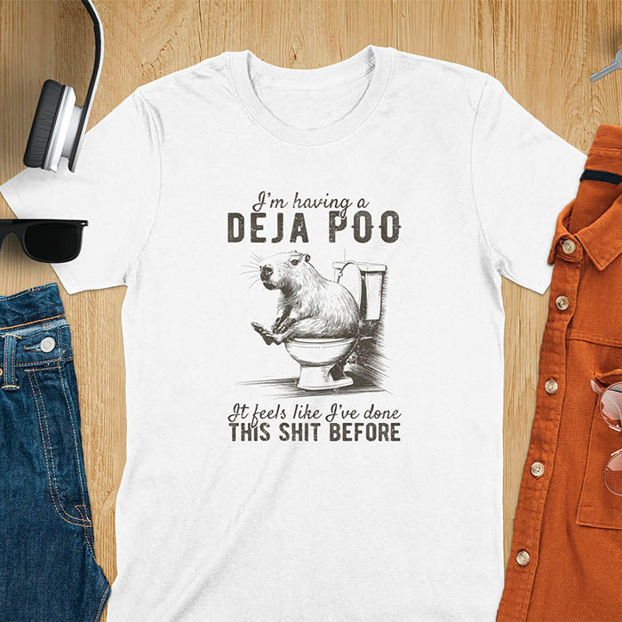 A t-shirt with a capybara seated on a toilet bowl. Text: "I'm having a Deja Poo It feels like I've done THIS SHIT BEFORE". A Capybara Deja Poo Shirt with Toilet Humor Gag Gift appeal. Inappropriate, offensive, weirdcore, funny meme, trending meme, genz gen z tee. Features kawaiiness, capybara cuteness, weird capybara gift. Great for animal person, pet lovers, animal lover, gift mom hers. A Retro Graphic Tshirt, y2k tee-shirt, Vintage Silly Party Tees, shirts that go hard.