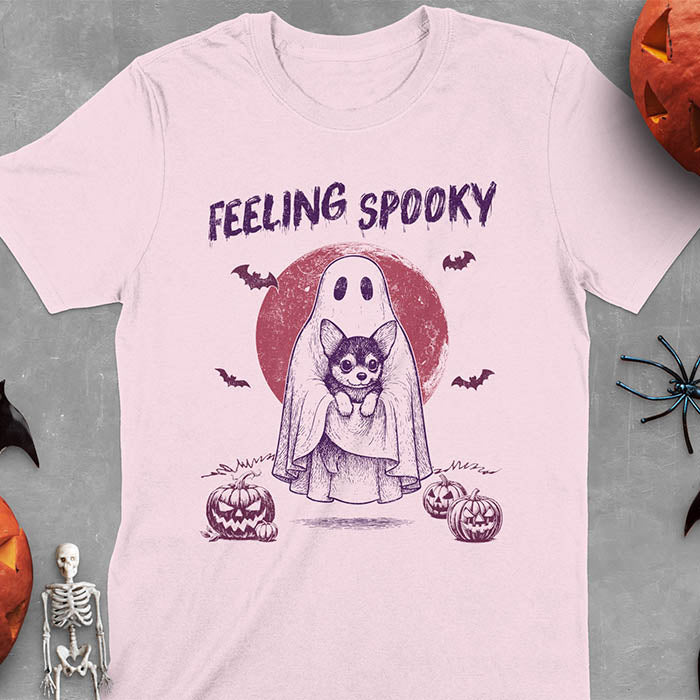 Light Pink t-shirt featuring a ghost holding a corgi puppy with 'Feeling Spooky' text above, red moon background with bats and jack-o'-lanterns