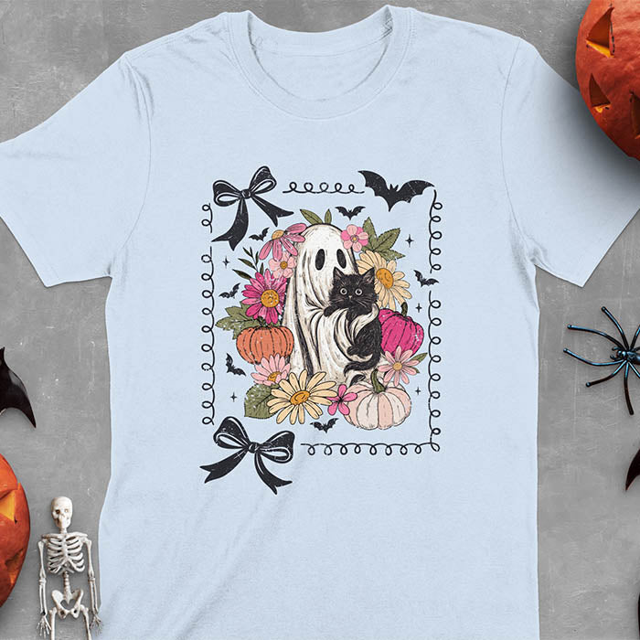 Light blue t-shirt featuring cute ghost holding black cat surrounded by pumpkins, bats, and floral elements in cottagecore coquette style