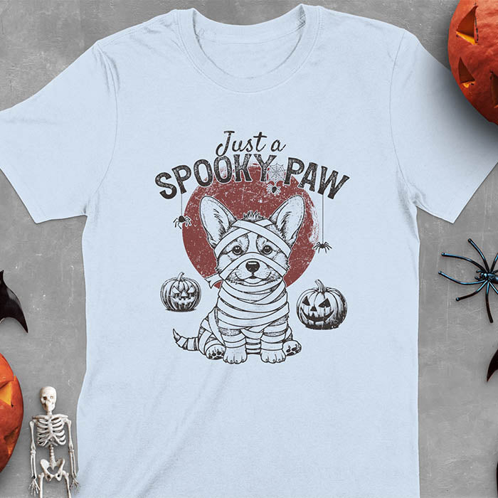 Light blue t-shirt with Halloween mummy corgi featuring "Just a Spooky Paw" text and wrapped corgi graphics