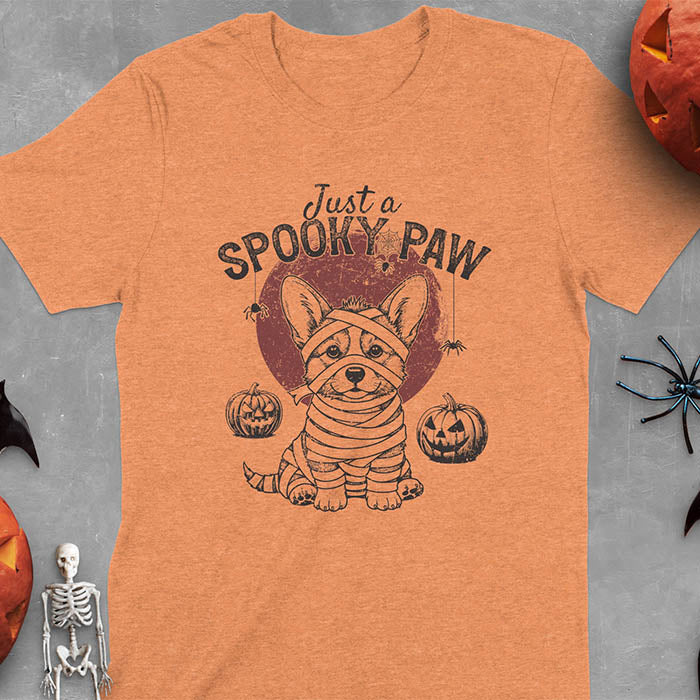 Heather Orange t-shirt with Halloween mummy corgi featuring "Just a Spooky Paw" text and wrapped corgi graphics