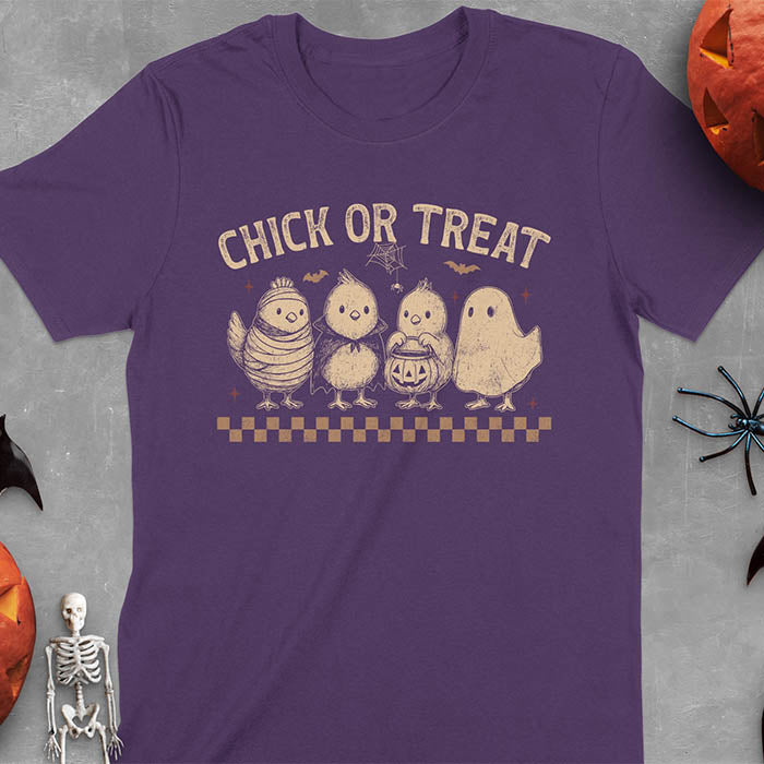 Purple t-shirt with Funny Halloween Chick Or Treat text featuring cartoon chickens dressed as spooky characters including ghost, mummy, vampire, and trick-or-treater