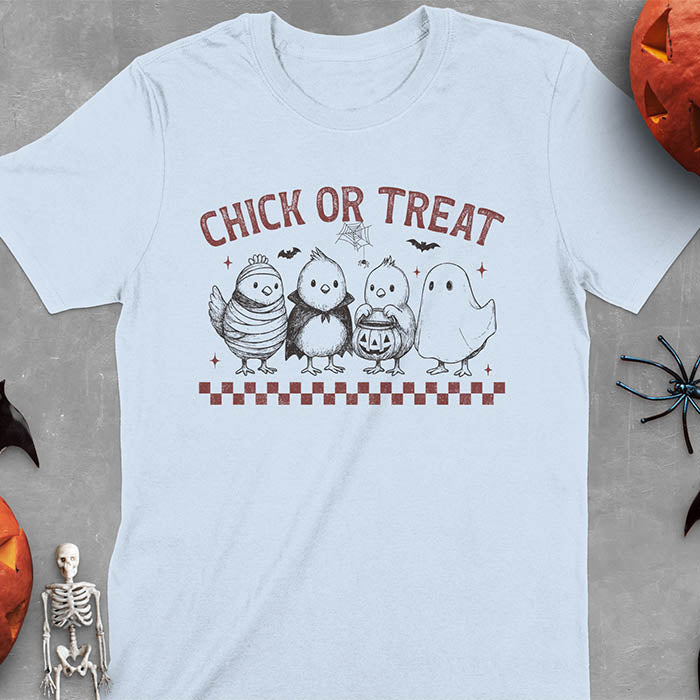 Light blue t-shirt with Funny Halloween Chick Or Treat text featuring cartoon chickens dressed as spooky characters including ghost, mummy, vampire, and trick-or-treater