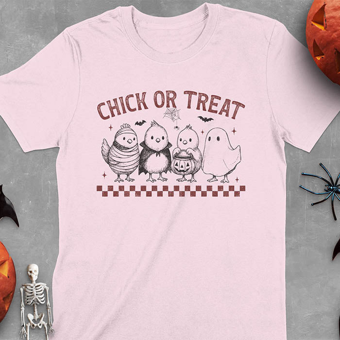 Light Pink t-shirt with Funny Halloween Chick Or Treat text featuring cartoon chickens dressed as spooky characters including ghost, mummy, vampire, and trick-or-treater