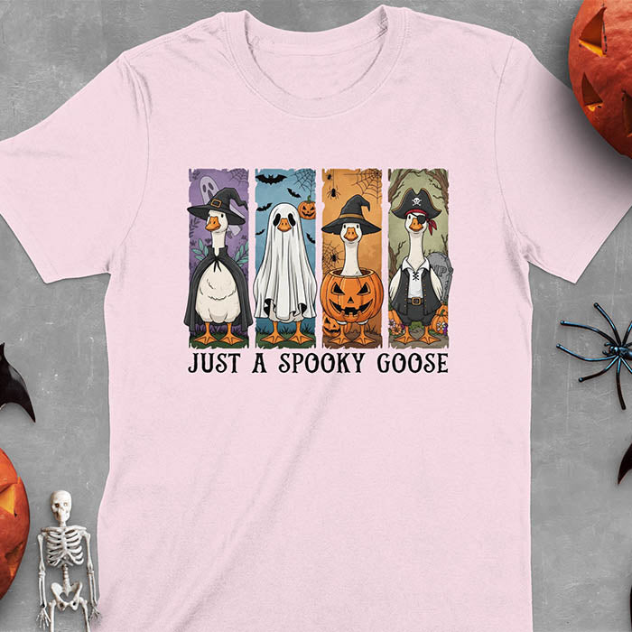 Light Pink Halloween Just a Spooky Goose t-shirt featuring ghost, pumpkin, witch, and pirate goose designs