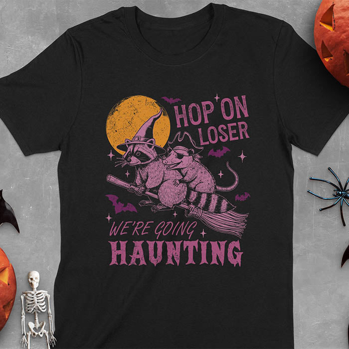 Black Halloween witch raccoon and opossum t-shirt with flying broom animal graphics