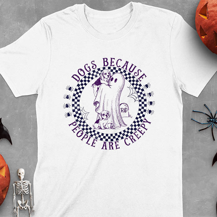 White Halloween t-shirt featuring a cute ghost holding a beagle puppy with another beagle sitting on the ground next to a tombstone marked 'RIP', surrounded by spiders in a circular checkered border design with text 'DOGS BECAUSE PEOPLE ARE CREEPY'