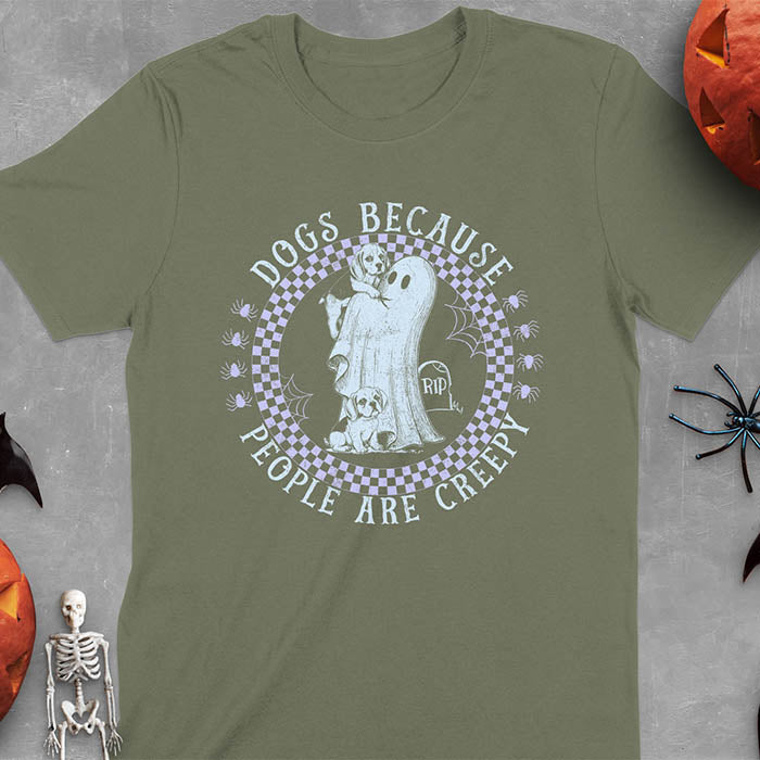 Military Green Halloween t-shirt featuring a cute ghost holding a beagle puppy with another beagle sitting on the ground next to a tombstone marked 'RIP', surrounded by spiders in a circular checkered border design with text 'DOGS BECAUSE PEOPLE ARE CREEPY'