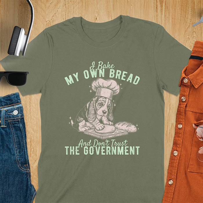 Military Green Basset Hound chef t-shirt with text 'I Bake MY OWN BREAD And Don't Trust THE GOVERNMENT' featuring basset puppy in chef's hat