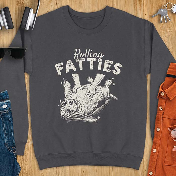 Dark Heather sweatshirt with a graphic of a basset hound lying on its back while a pair of hands knead its rolled up folds like dough and the text Rolling Fatties