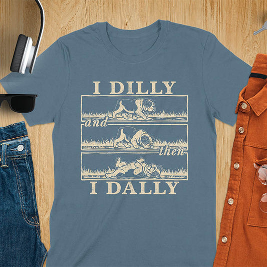 Indigo blue t-shirt with vintage comic strip graphic of a bulldog walking, rolling, then lying belly-up with text I Dilly and then I Dally