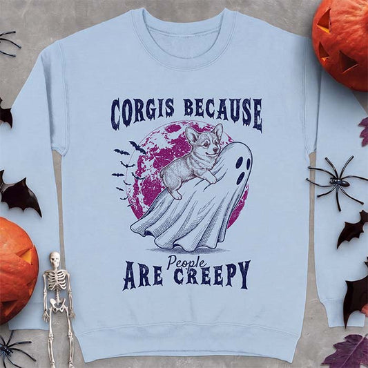 Light Blue sweatshirt with a Halloween graphic of a Corgi puppy sitting on a sheet ghost before a glowing moon with bats, with the text "Corgis Because People Are Creepy" underneath