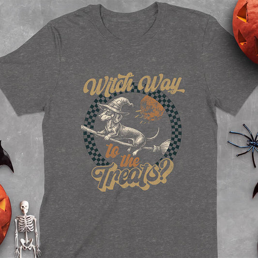 Dark Heather t-shirt with a Halloween graphic of a dachshund in a witch hat riding a broomstick past a full moon with bats flying nearby and the text Witch Way To The Treats?