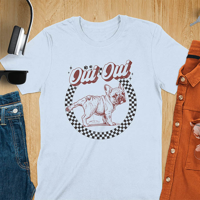 French Bulldog Oui Oui pun t-shirt with checkered circle border and retro script lettering on light blue tee