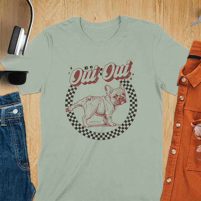 French Bulldog Oui Oui pun t-shirt with checkered circle border and retro script lettering on sage green tee