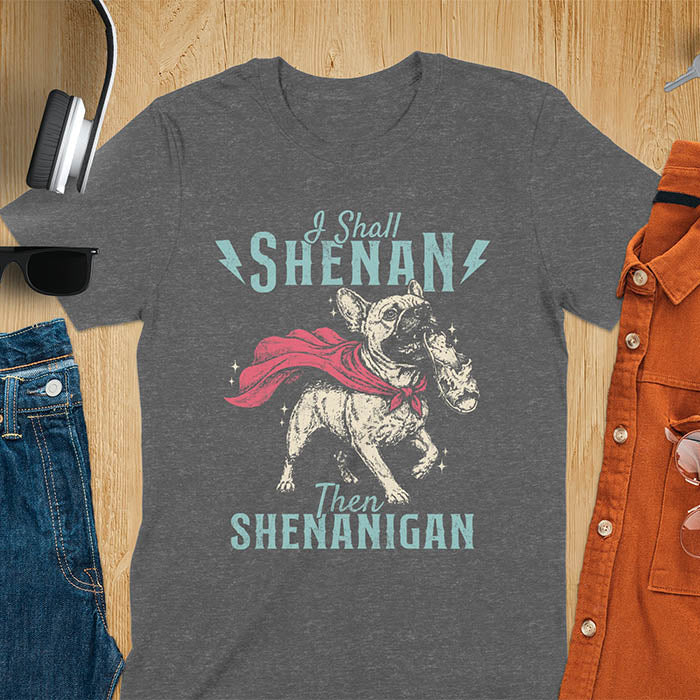 Dark heather tee with vintage Frenchie in red cape biting on a chewed slipper, text reads I Shall Shenan Then Shenanigan